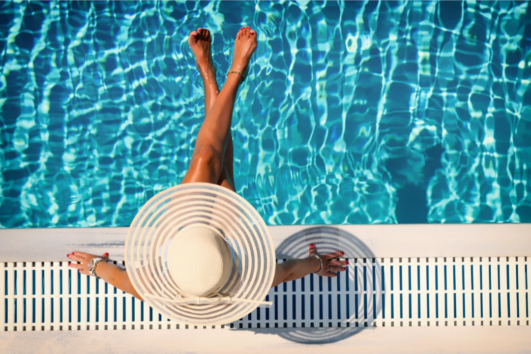 Woman at the pool in sun hat